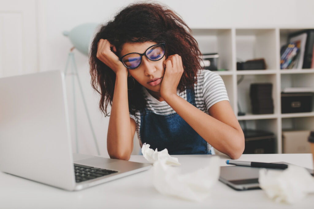 A working woman sleeping while at work. procrastination at play.