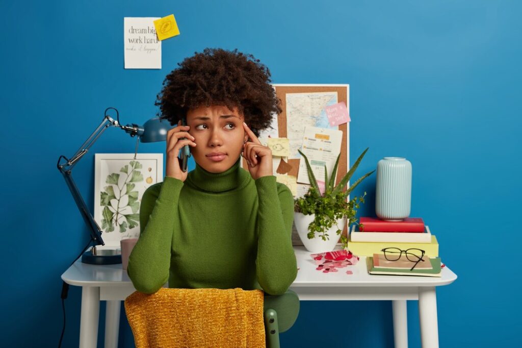 Picture of a black woman thinking, signifying growth vs fixed mindset