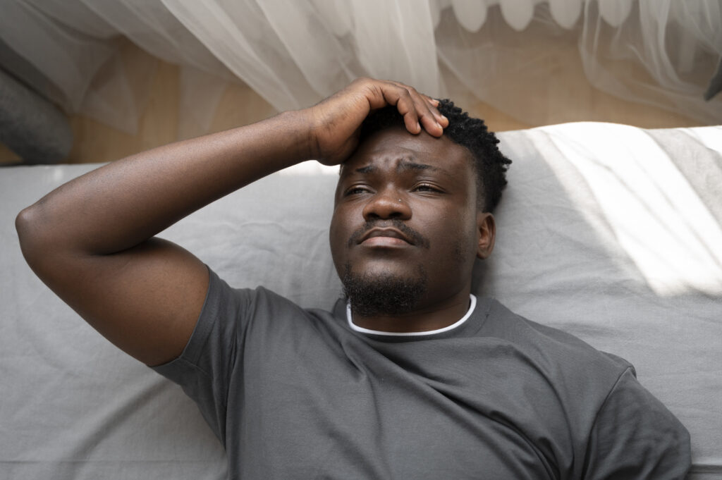 Picture of a young, depressed adult at home. Procrastination can cause depression.