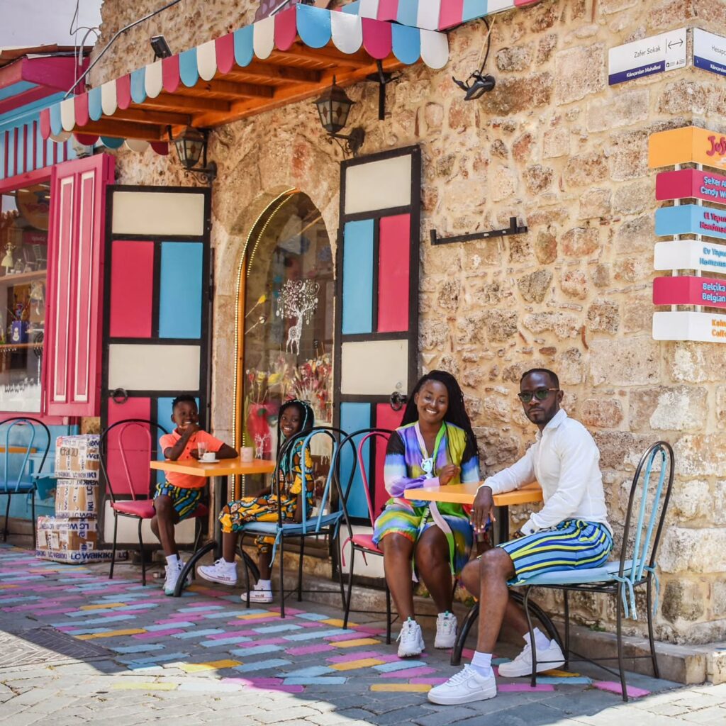 A picture of Ghanaian celebrity Okyeame Kwame and family spending quality time together outdoors.