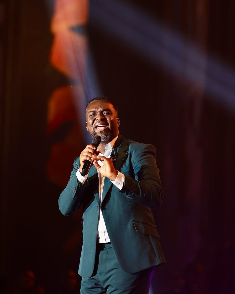 Gospel musician Joe mettle performing on stage, inspired by faith and love in marriage