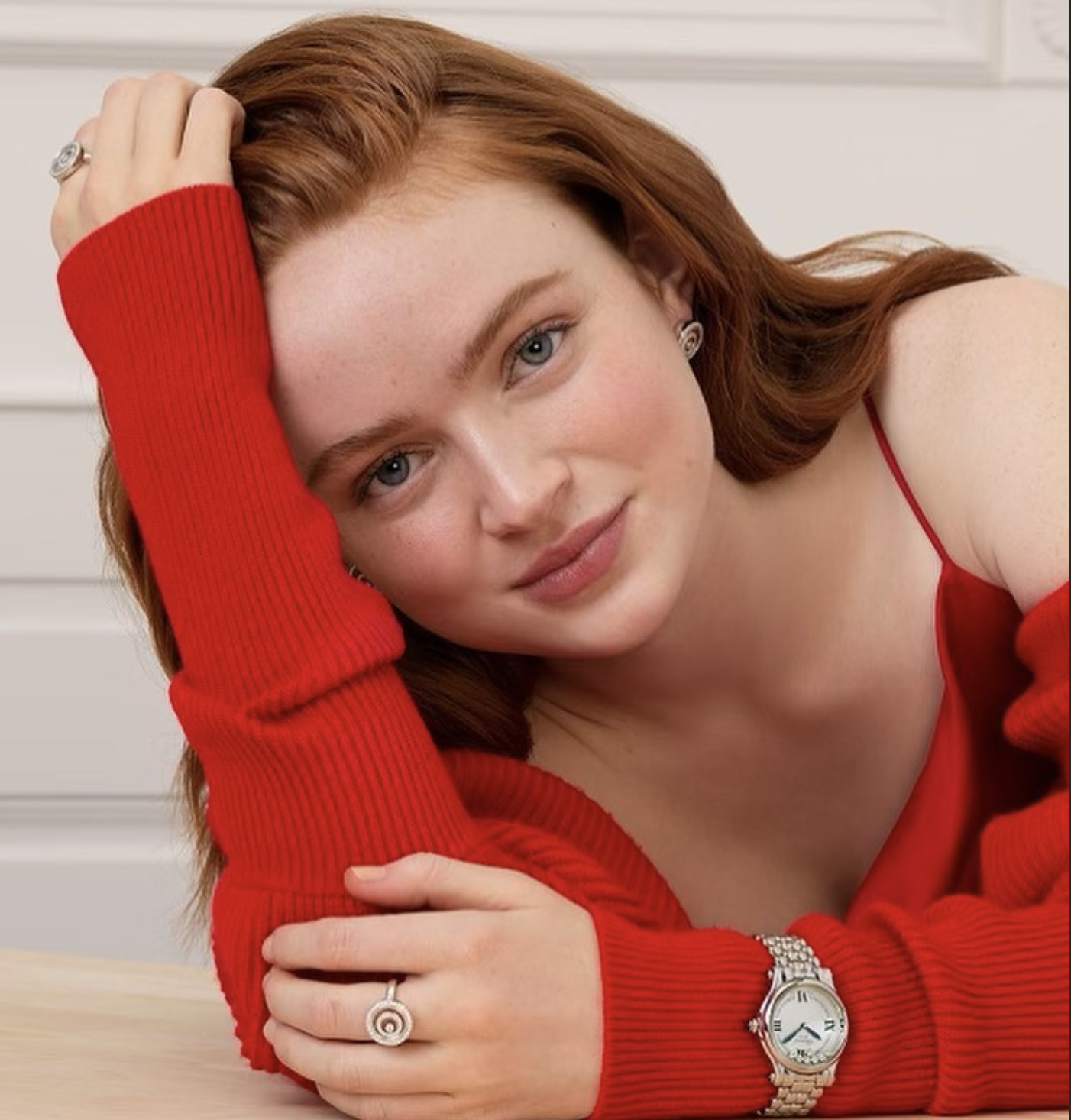 Close-up portrait of Sadie Sink in red outfit, relaxed pose with soft natural smile