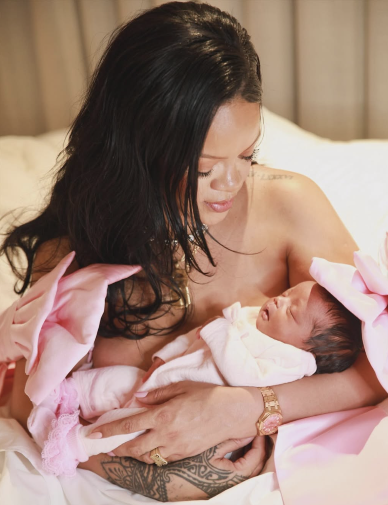 Rihanna holding her newborn baby girl in an intimate motherhood moment, showing emotional bonding and maternal love