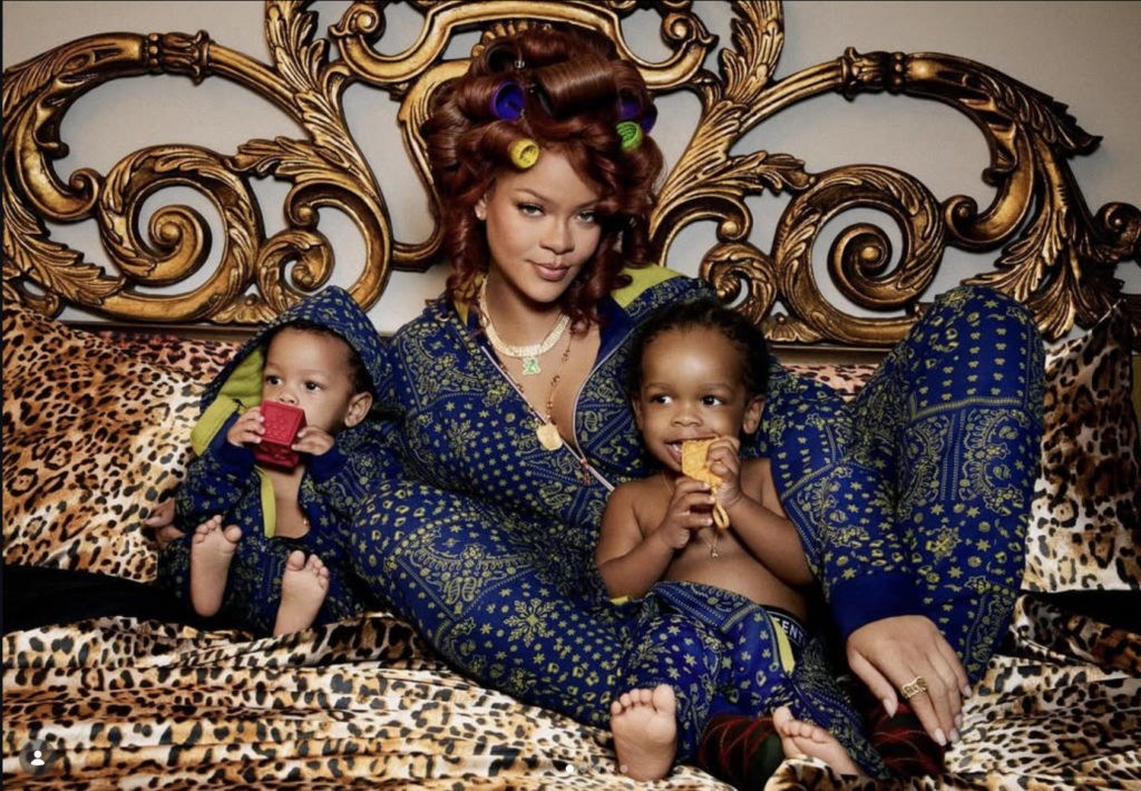 Rihanna sitting with her two sons in a family portrait, showing motherhood, legacy, and balance between family and personal identity