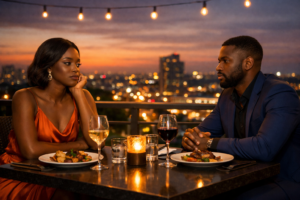 Ghanaian couple dressed elegantly sitting across from each other at a rooftop restaurant at sunset, looking emotionally distant with untouched food on the table