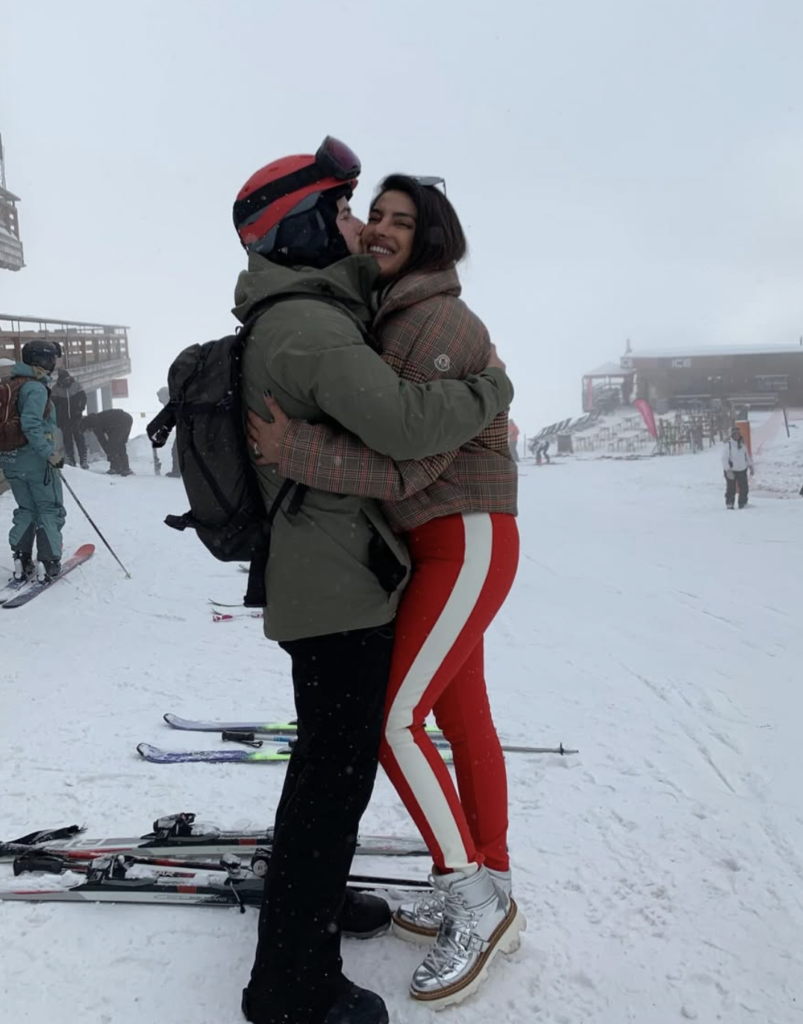 Priyanka Chopra and Nick Jonas hugging in the snow during a ski trip