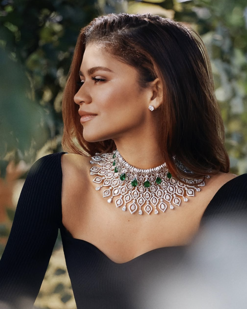 Zendaya wearing a diamond and emerald necklace at a fashion event