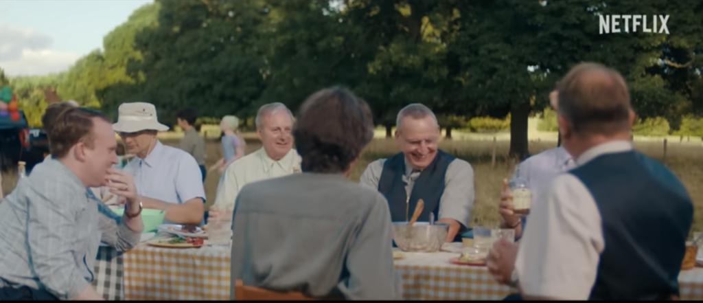 Members of a religious community share a meal outdoors in The Unchosen Netflix series.