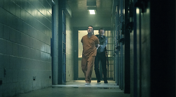 David Burroughs is escorted through a prison corridor while serving time for a crime he insists he did not commit.