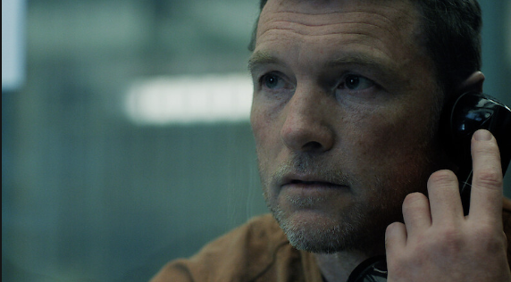David Burroughs speaks on a prison telephone after receiving information that could change everything.