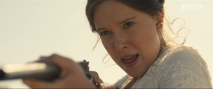 Enola Holmes aims a rifle during an action scene in Enola Holmes 3 on Netflix.