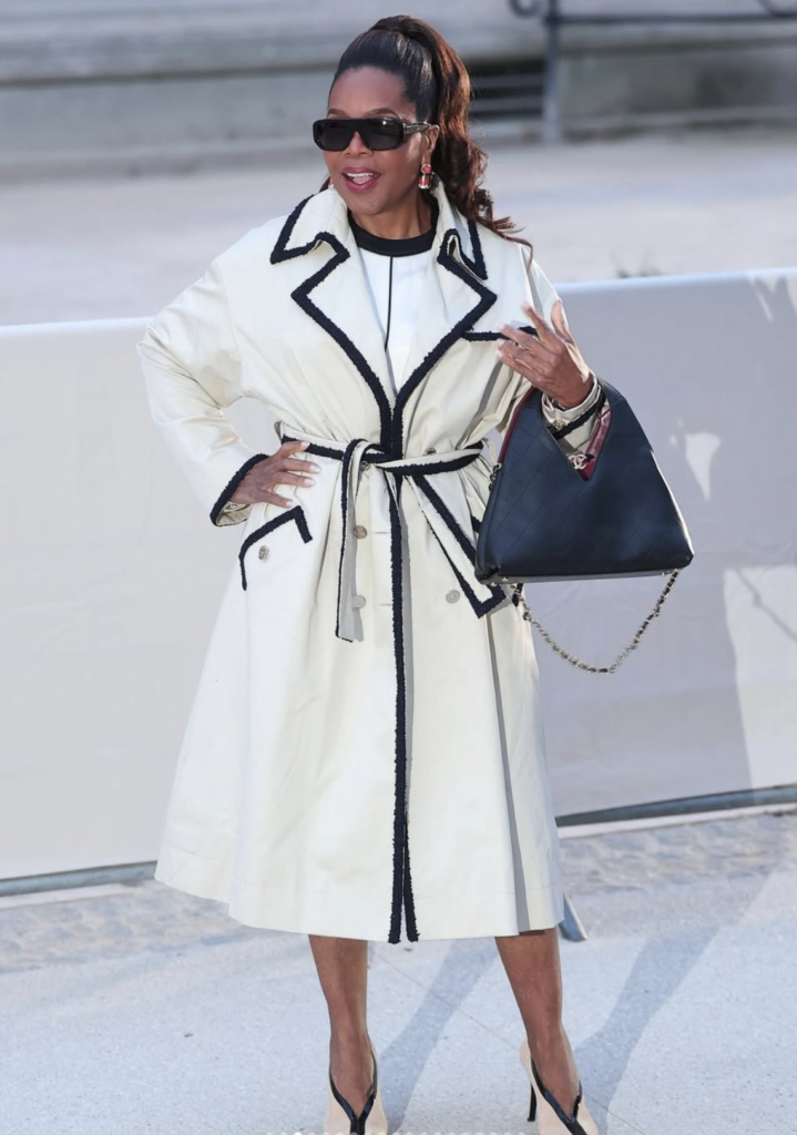 Oprah Winfrey wearing a white coat and sunglasses outdoors